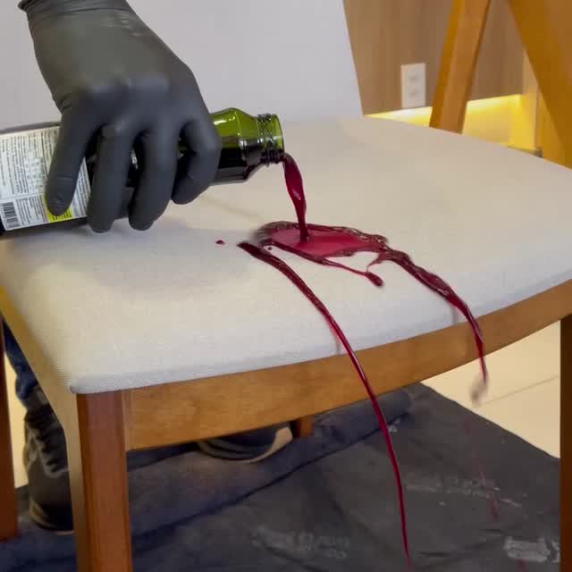 Técnico de Doctor Sofá, con mascarilla, gafas, guantes y protección en los pies, limpiando los cojines de un sofá claro.